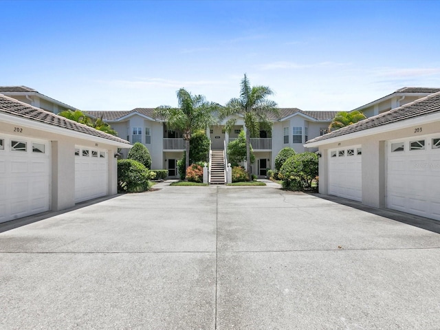 view of front of property featuring a residential view and community garages