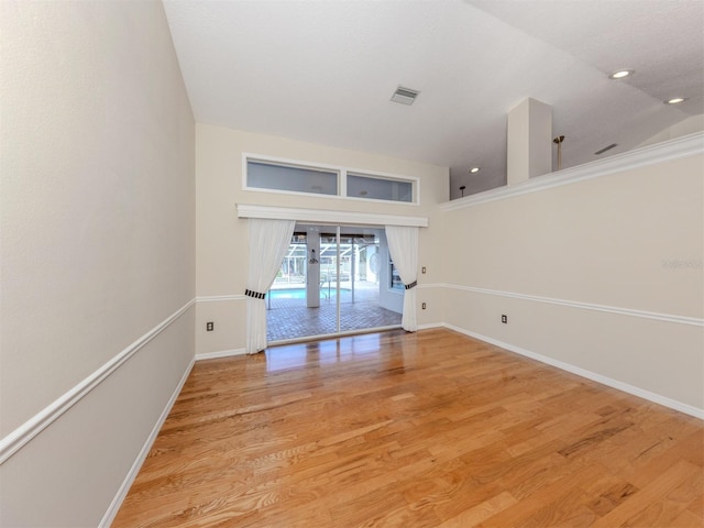 314 Oakwood Cir, Englewood, FL 34223 - spare room featuring light wood-style flooring, baseboards, and visible vents