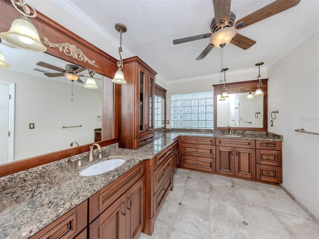 314 Oakwood Cir, Englewood, FL 34223 - full bathroom with crown molding, vanity, ceiling fan, and a textured ceiling