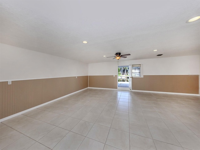 314 Oakwood Cir, Englewood, FL 34223 - empty room featuring wainscoting, ceiling fan, light tile patterned flooring, and recessed lighting