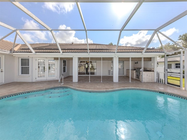 314 Oakwood Cir, Englewood, FL 34223 - pool featuring a patio area, an outdoor kitchen, glass enclosure, and french doors