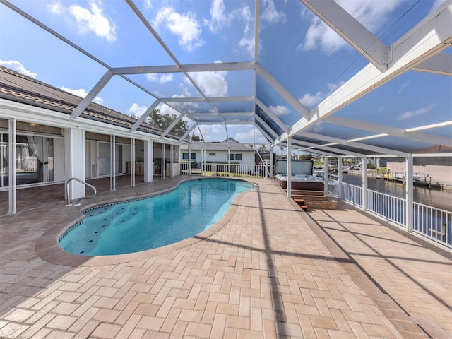 314 Oakwood Cir, Englewood, FL 34223 - pool with a hot tub, a patio area, a water view, and glass enclosure