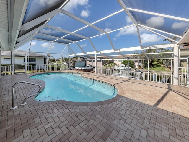 314 Oakwood Cir, Englewood, FL 34223 - outdoor pool with fence, a patio, a jacuzzi, and glass enclosure