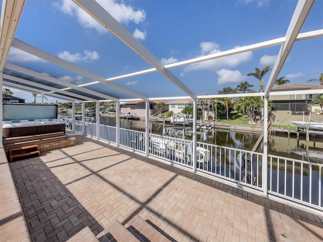 314 Oakwood Cir, Englewood, FL 34223 - view of patio with a hot tub, a boat dock, boat lift, and glass enclosure