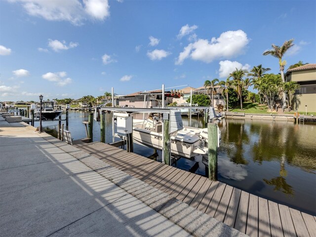314 Oakwood Cir, Englewood, FL 34223 - view of dock featuring boat lift and a water view