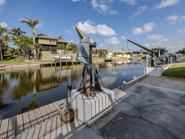 314 Oakwood Cir, Englewood, FL 34223 - view of dock featuring boat lift and a water view