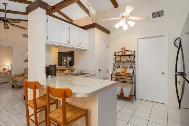 5559 Brassy Loop, North Port, FL 34287 - kitchen with a ceiling fan, a sink, light countertops, a peninsula, and beamed ceiling