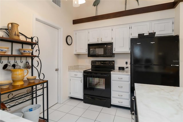 5559 Brassy Loop, North Port, FL 34287 - kitchen featuring black appliances, light countertops, white cabinetry, and light tile patterned floors
