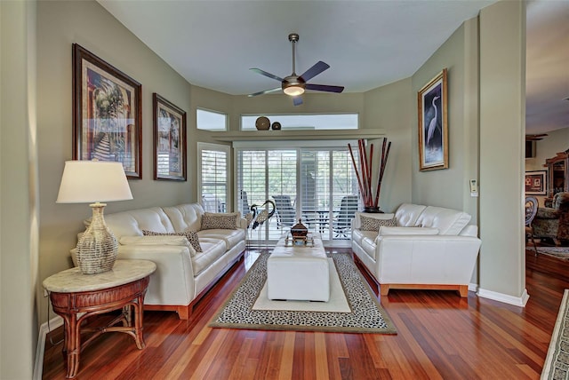 living room with dark wood-type flooring, baseboards, and ceiling fan