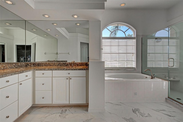 bathroom featuring a stall shower, a garden tub, recessed lighting, and marble finish floor