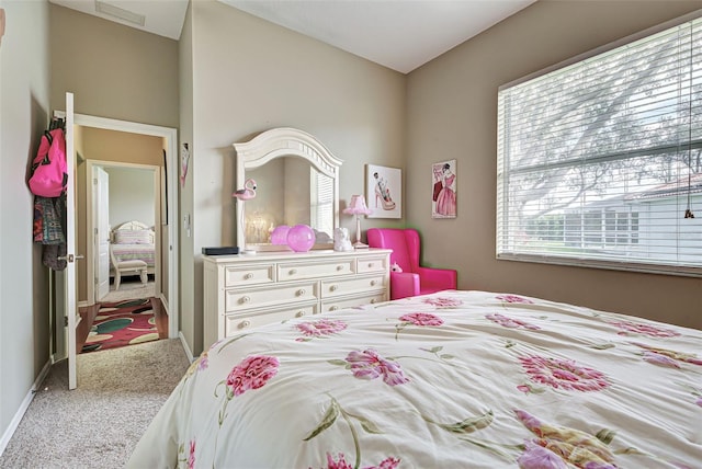 carpeted bedroom with visible vents and baseboards