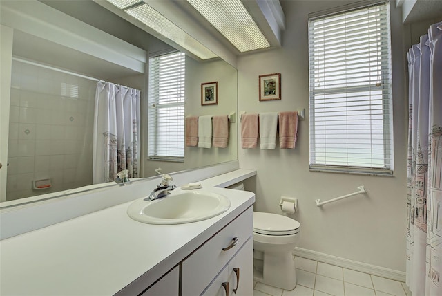 bathroom with a shower with curtain, tile patterned flooring, baseboards, vanity, and toilet