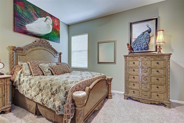 bedroom with baseboards and light carpet