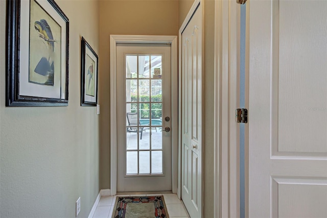 entryway featuring baseboards and light tile patterned flooring