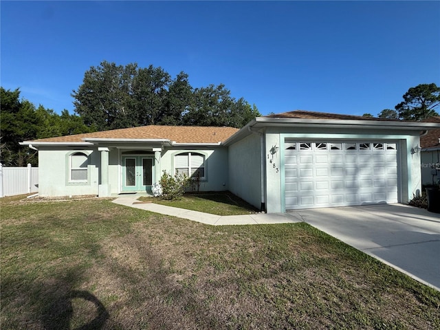 1483 Prairie Ter, North Port, FL 34286 - single story home with french doors, an attached garage, stucco siding, and concrete driveway