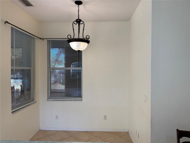 1483 Prairie Ter, North Port, FL 34286 - unfurnished dining area with light tile patterned flooring, baseboards, and plenty of natural light