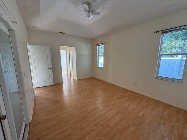 1483 Prairie Ter, North Port, FL 34286 - spare room with light wood-style floors, healthy amount of natural light, a ceiling fan, baseboards, and a textured ceiling
