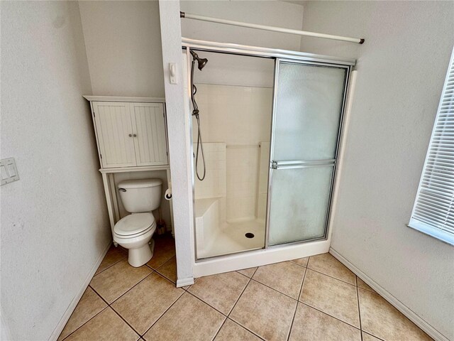 1483 Prairie Ter, North Port, FL 34286 - full bath featuring a stall shower, toilet, tile patterned flooring, and baseboards