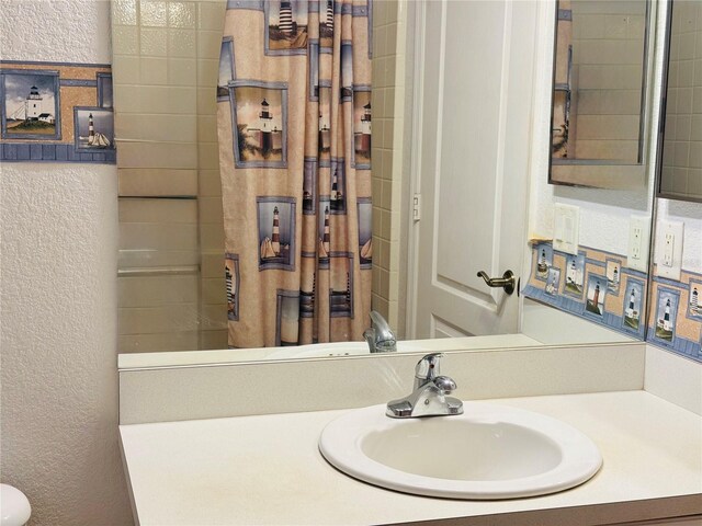 1483 Prairie Ter, North Port, FL 34286 - full bath featuring a textured wall, vanity, and a shower with curtain