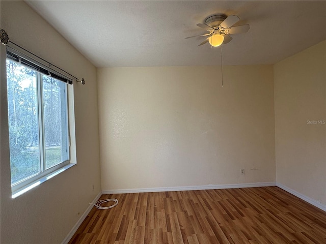 1483 Prairie Ter, North Port, FL 34286 - empty room featuring wood finished floors, plenty of natural light, a ceiling fan, and baseboards