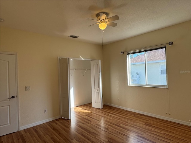 1483 Prairie Ter, North Port, FL 34286 - unfurnished bedroom featuring wood finished floors, a closet, baseboards, and ceiling fan