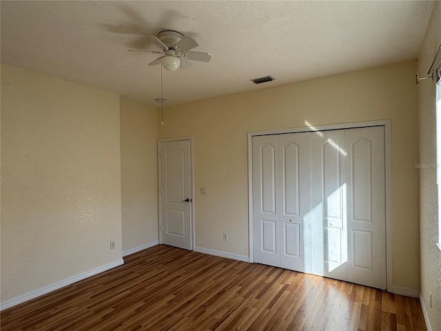 1483 Prairie Ter, North Port, FL 34286 - unfurnished bedroom with wood finished floors, a closet, baseboards, and ceiling fan