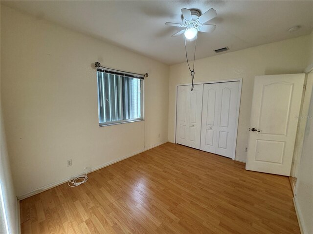 1483 Prairie Ter, North Port, FL 34286 - unfurnished bedroom featuring light wood-style flooring, baseboards, a closet, and a ceiling fan