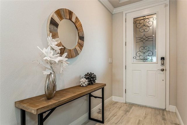 entryway featuring baseboards and ornamental molding