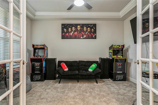sitting room featuring ornamental molding, carpet floors, ceiling fan, and baseboards