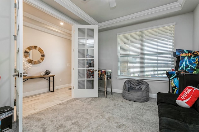 sitting room with french doors, crown molding, carpet floors, and baseboards