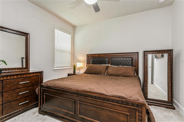 bedroom with light colored carpet, a ceiling fan, and baseboards