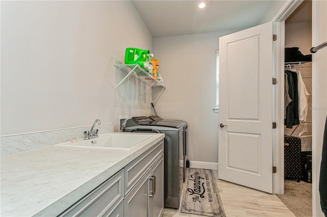 laundry area featuring independent washer and dryer, cabinet space, light wood-style flooring, and recessed lighting