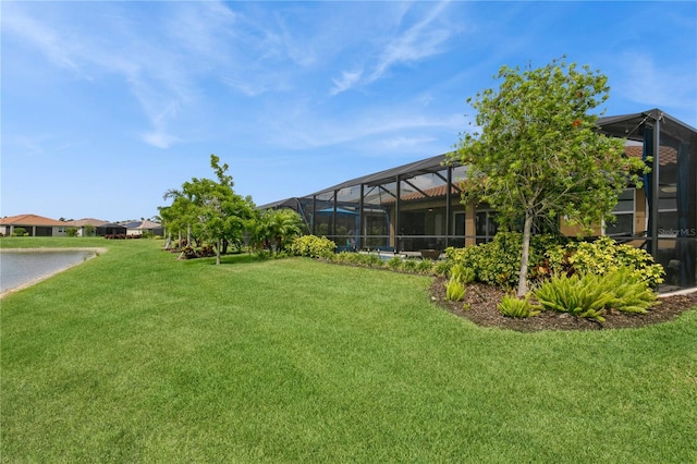 view of grassy yard featuring glass enclosure