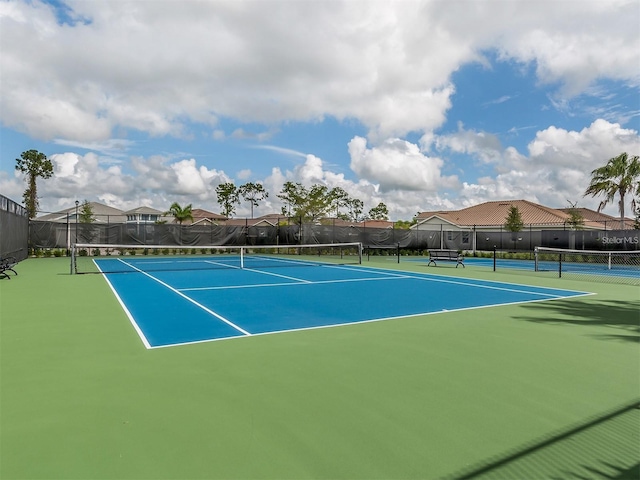 view of tennis court with fence