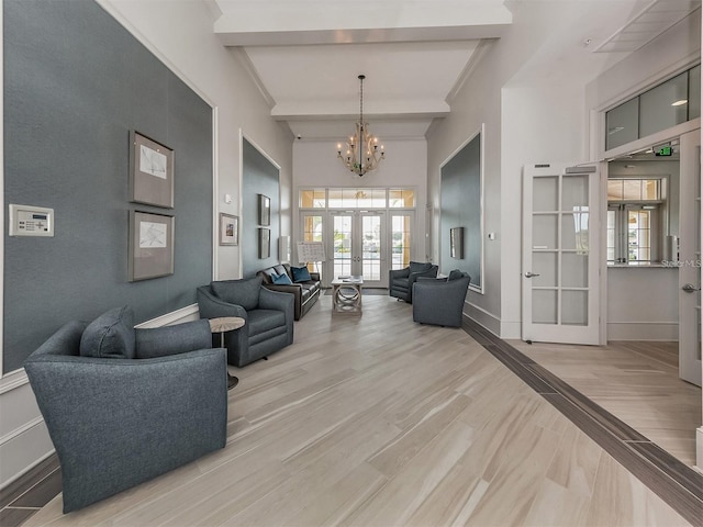 living area with french doors, plenty of natural light, a chandelier, baseboards, and beam ceiling