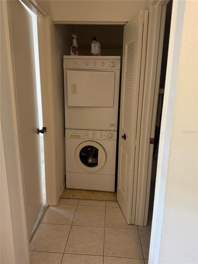 744 Avenida Estancia Unit 144, Venice, FL 34292 - clothes washing area featuring laundry area, stacked washer / dryer, and light tile patterned floors