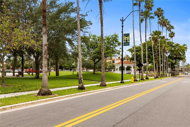 view of street with curbs, street lights, and sidewalks