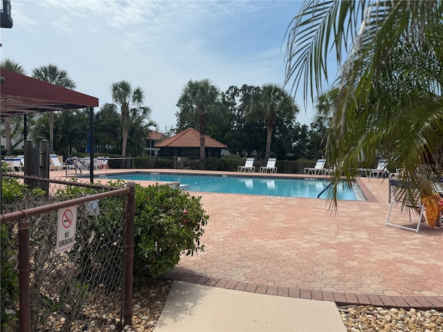pool featuring a patio area, a gazebo, and fence
