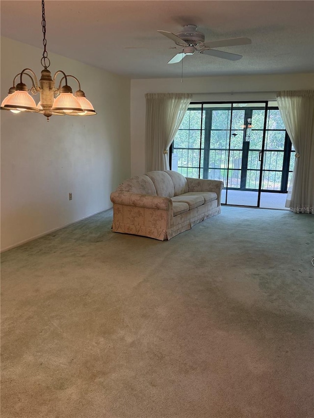 carpeted living area featuring a wealth of natural light and a ceiling fan