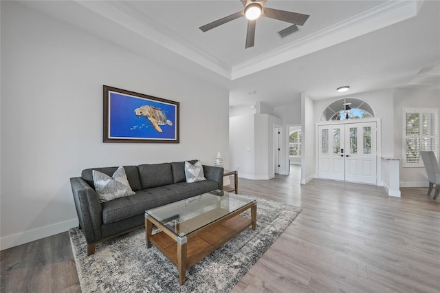 4532 Chase Oaks Dr, Sarasota, FL 34241 - living area featuring a raised ceiling, ceiling fan, baseboards, wood finished floors, and crown molding