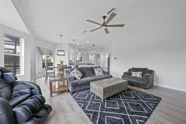 4532 Chase Oaks Dr, Sarasota, FL 34241 - living area with ceiling fan, wood finished floors, and baseboards