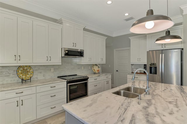 kitchen with appliances with stainless steel finishes, a sink, hanging light fixtures, light stone counters, and crown molding