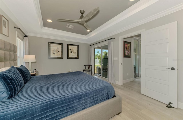 bedroom featuring a raised ceiling, access to exterior, light wood-style flooring, ornamental molding, and recessed lighting