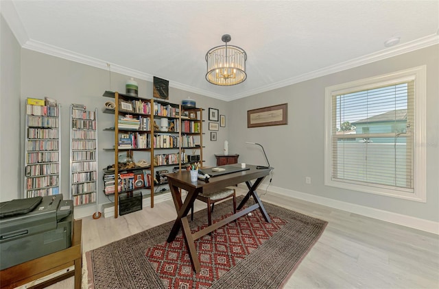 office space with light wood-style flooring, ornamental molding, a chandelier, and baseboards