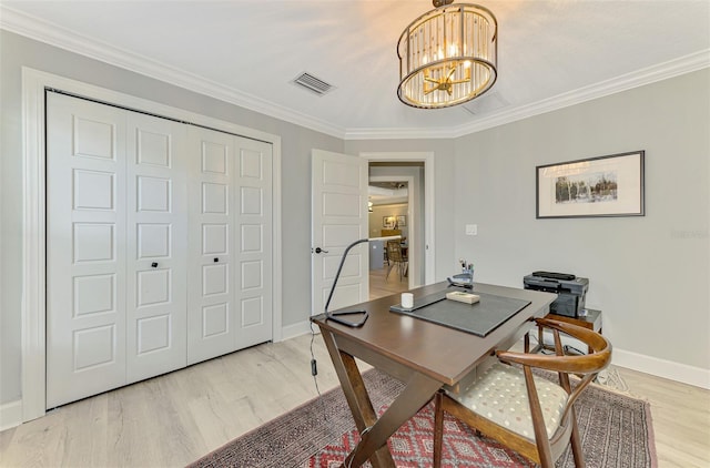home office with light wood-style flooring, a chandelier, ornamental molding, and baseboards