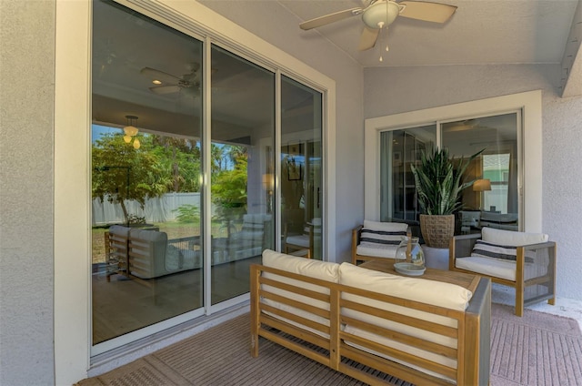 sunroom with ceiling fan, vaulted ceiling, and an outdoor living space