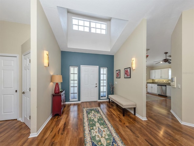 foyer entrance with baseboards, a wealth of natural light, ceiling fan, and wood finished floors
