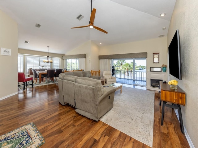 living room with a wealth of natural light, visible vents, and wood finished floors