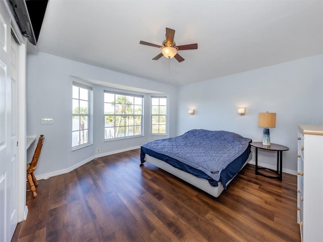 bedroom featuring baseboards, a ceiling fan, and wood finished floors