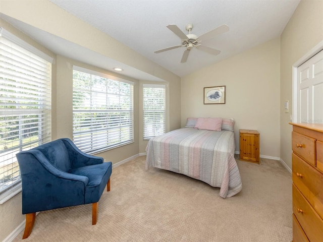 bedroom with light colored carpet and baseboards